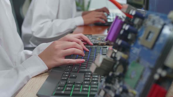 Development Facility: Engineer Working On Computer, Typing With Her Hands On A Keyboard