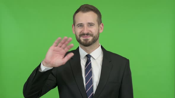 Ambitious Businessman Waving Hand Sign Against Chroma Key