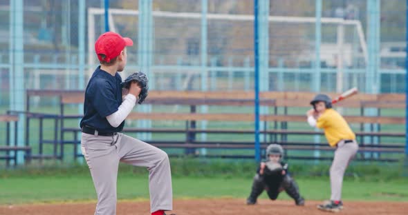 Baseball Tournament at School, Boys Play Baseball, the Pitcher Throws the Ball Toward a Batter