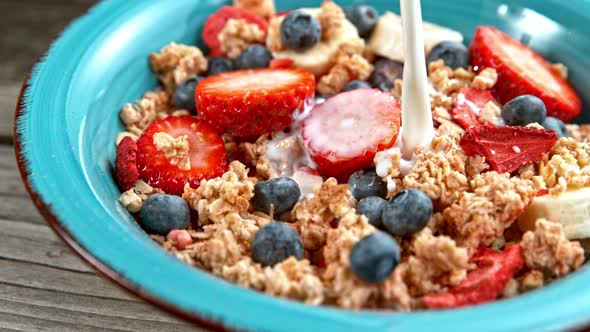 Pouring Milk on Cereals at Bowl in Super Slowmotion