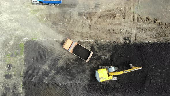 Aerial view of the construction site. Special machinery digs a pit. Work machinery.