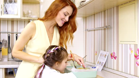 Mom and Daughter Have Fun Cooking Together, Mother Teaches Her Child To Cook Pie