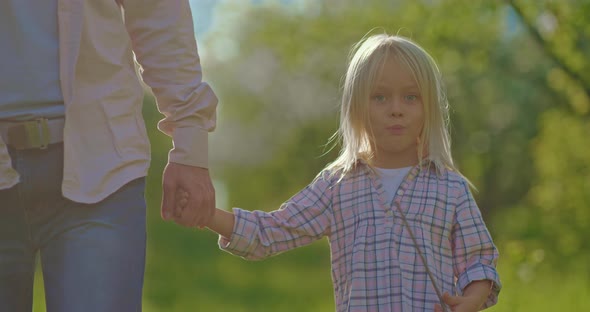 Cute Little Girl with Blonde Hair is Walking in Park with Father Child Portrait  Prores