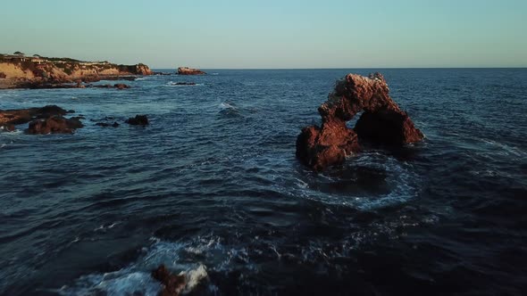 Orange County Southern California coastline with unique rock formations and sea birds in flight