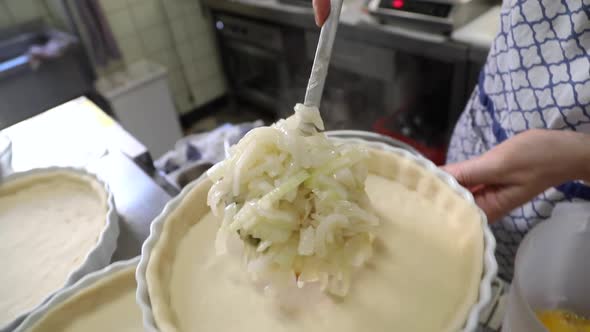 Putting freshly cooked white onions for a delicious onion tart -close up