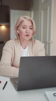 A Pensioner Communicates with a Friend Via Video Link Through a Laptop