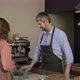 Handsome Male Cashier in Apron and Gloves Accepts Terminal Payment From Female Customer - VideoHive Item for Sale