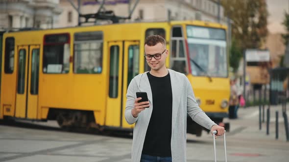 A Man is Standing at the Train Station