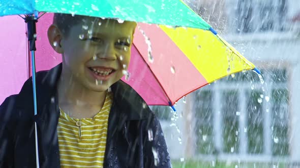 Little Boy Catching Raindrops