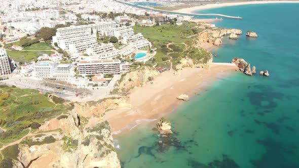 Top view over stunning Dona Ana sandy beach in Idyllic Lagos shoreline, in Algarve, Portugal