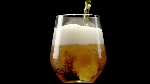 Beer pour into glass on rotating display turntable