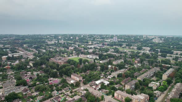 Aerial View of a Small Town Urban Landscape Flying By Houses Near Green Spaces