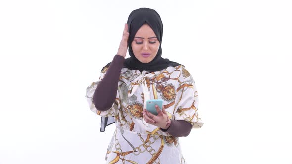 Stressed Young African Muslim Woman Using Phone and Getting Bad News