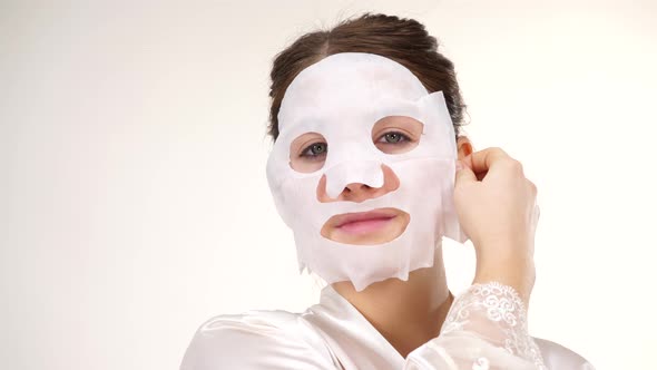 Woman Remove Sheet Mask from Face