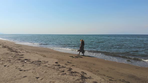 Girl Walking Alone at Long Seashore