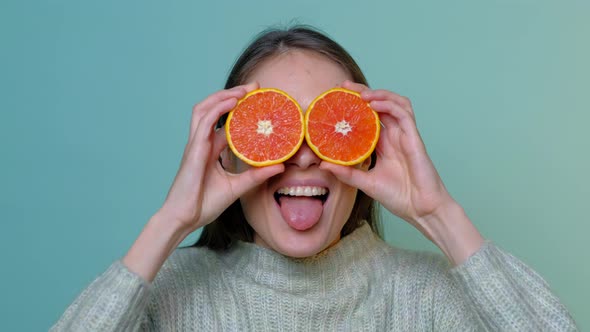 Female Fooling Around in Front of Camera with Grapefruit