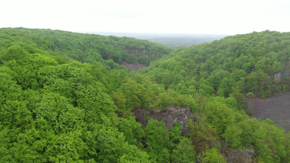 Aerial view of national park in rain, flying over hill, Sweden