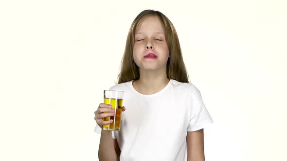 Girl Drinks Apple Juice, Licks Her Lips After the Juice. White Background. Slow Motion