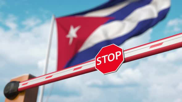 Opening Boom Barrier with Stop Sign Against the Cuban Flag alt