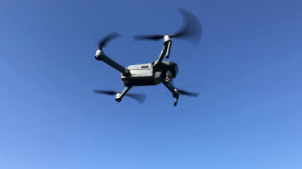 Drone Flying Against Blue Sky