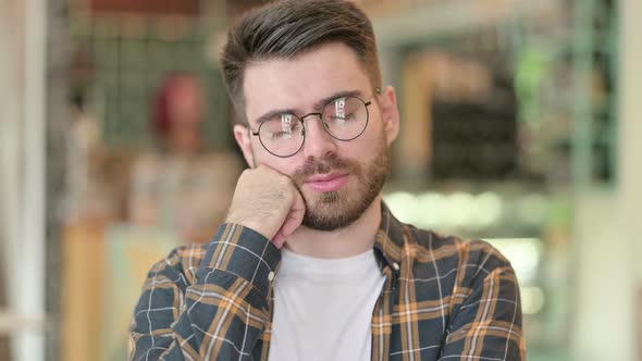 Portrait of Tired Young Man Taking Nap