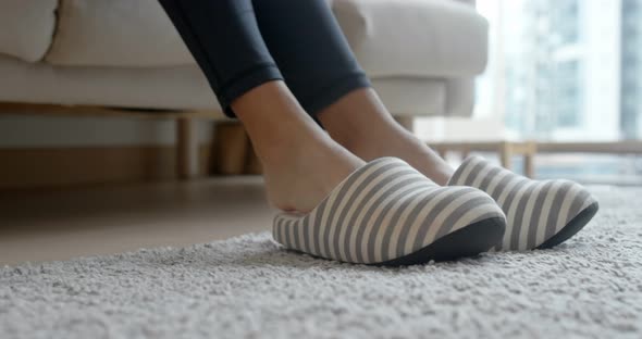 Woman wearing slipper at home