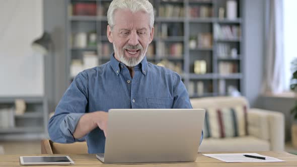 Ambitious Old Man Celebrating Success on Laptop