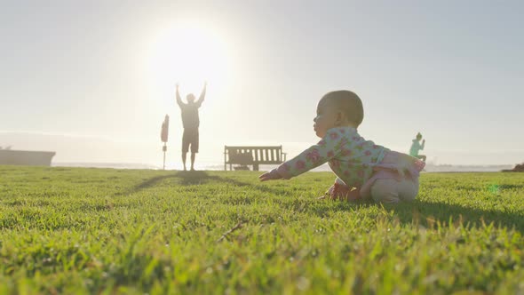 Happy Baby Crawls in the Grass