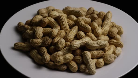 Cinematic, rotating shot of peanuts on a white surface - PEANUTS 021