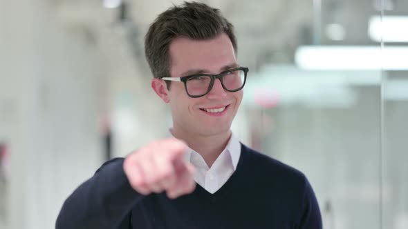 Assertive Young Businessman with Pointing at the Camera