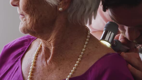 Doctor examining a senior woman in a retirement home