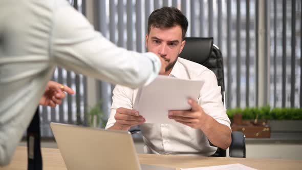 Colleagues and executives overwhelmed young male head of the office with work