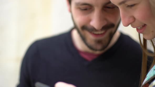 Couple using multimedia smartphone together