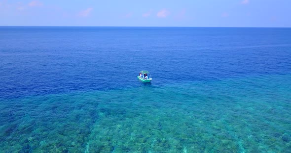 Wide aerial clean view of a sunshine white sandy paradise beach and turquoise sea background in vibr