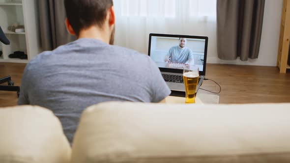 Cheerful Brothers Playing Chess on Video Call