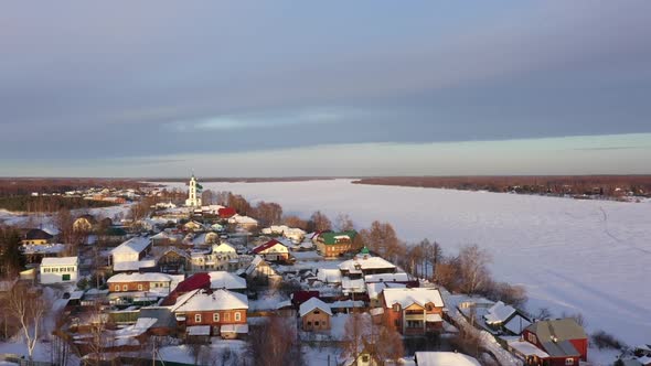 Winter Landscape of a Russian Village with a Church on the River Bank