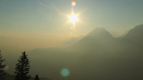 Pan Shot of Beautiful Mountain Landscape With Golden Haze in Air, Romantic View