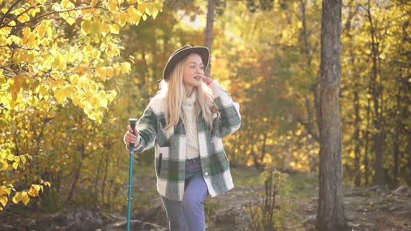 Sportive Hiking Woman Is Climbing Mountains Using Hiking Cane.