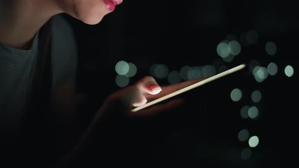 Female Hands Is Typing on a Smartphone at Night