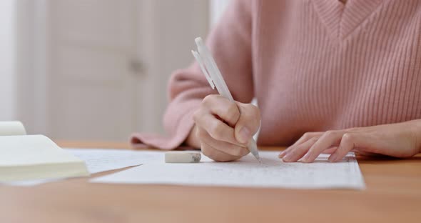 Woman write on the paper for study at home