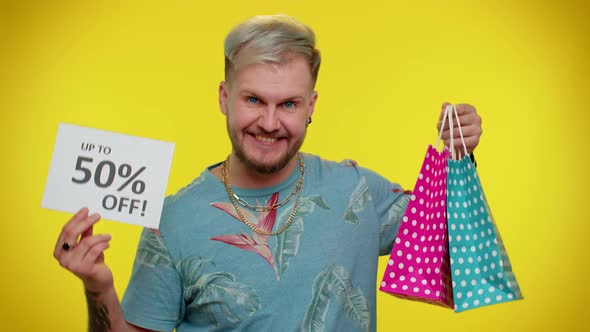 Cheerful Tourist Man Showing Shopping Bags and Up To 50 Percent Off Inscriptions Banner Black Friday