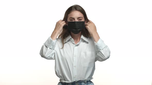 Video of Attractive Brunette Woman in White Shirt Takingoff Black Medical Mask Inhaling Air and