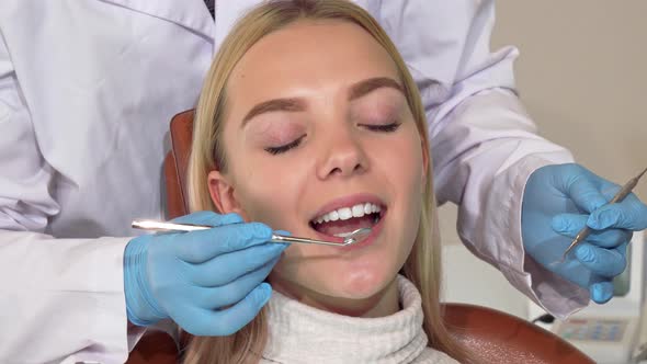 Happy Woman Smiling To the Camera After Getting Her Teeth Checked By Dentist