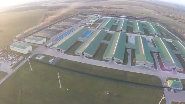 Flying over the farm facilities at sunset