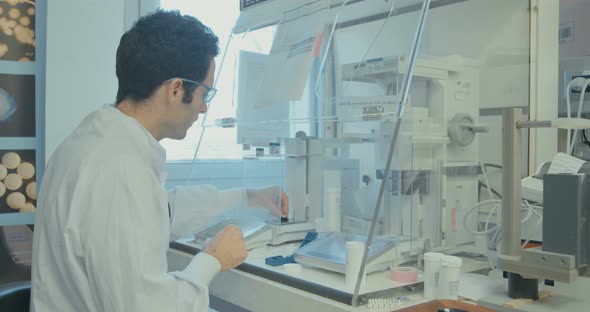 Scientist working in a pharmaceutical laboratory weighing chemicals