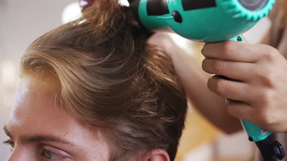 Female Hairdresser Making Hairstyle to Man in Beauty Salon Slow Motion Close Up