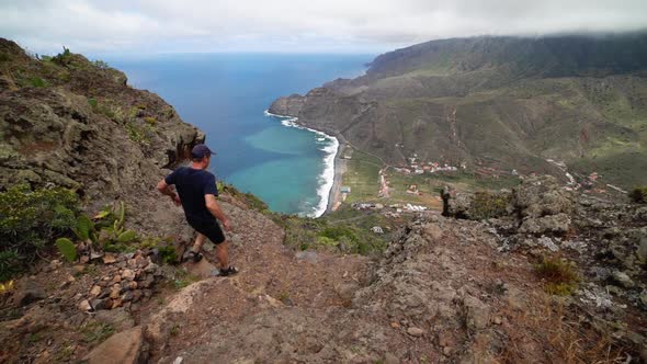 Man Walking On Mountainside