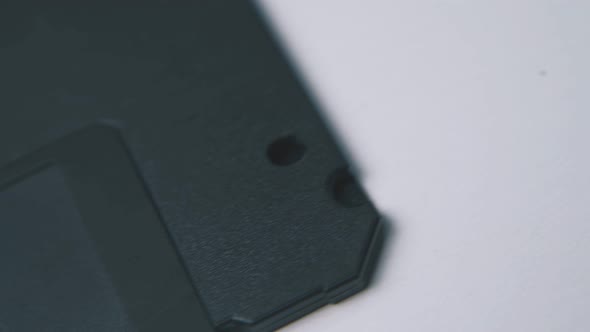 Motion Along Floppy Disk in Black Case on White Surface