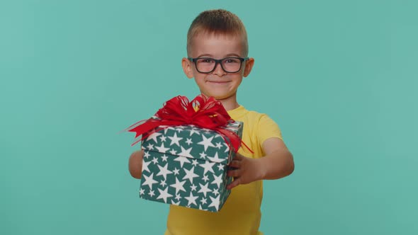 Smiling Toddler Children Boy Presenting Birthday Gift Box Stretches Out Hands Offer Wrapped Present