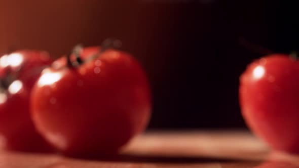 Fresh tomato bouncing on table. Slow Motion.